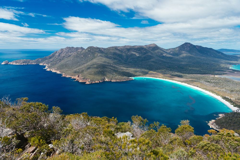 aerial photo of water and mountains at wineglass bay